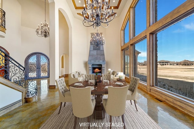 dining area featuring arched walkways, finished concrete flooring, a high ceiling, and an inviting chandelier