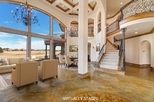 living room with a high ceiling, a notable chandelier, and arched walkways