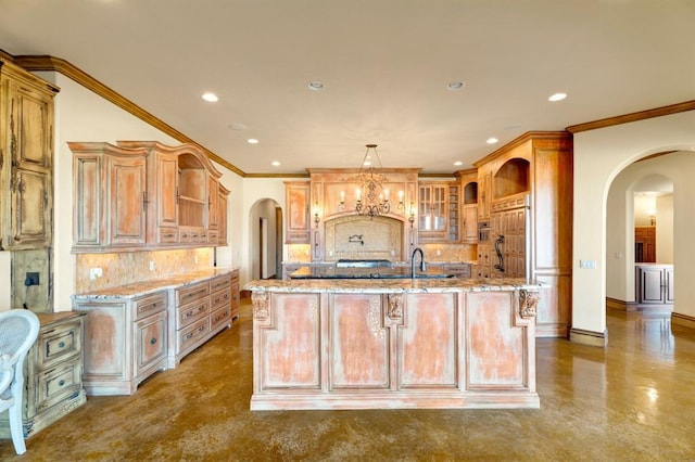 kitchen featuring arched walkways, a center island with sink, open shelves, and light stone countertops