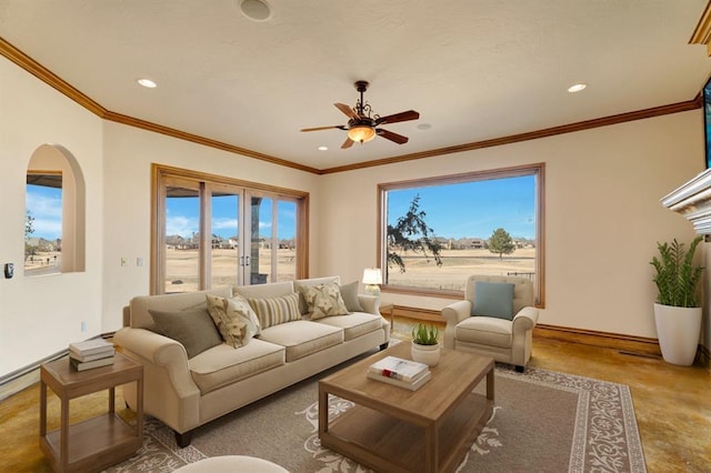 living area with recessed lighting, baseboards, ornamental molding, and a ceiling fan