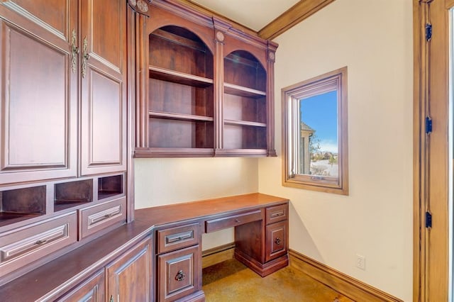 home office featuring baseboards and built in desk