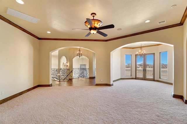 unfurnished room featuring visible vents, ceiling fan with notable chandelier, baseboards, and carpet floors