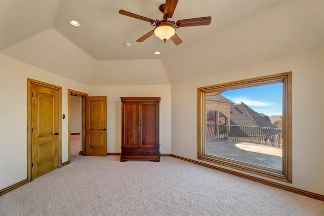 unfurnished bedroom featuring lofted ceiling, recessed lighting, carpet, baseboards, and access to exterior