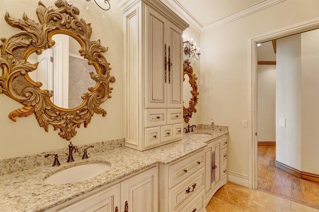 bathroom with double vanity, crown molding, baseboards, and a sink