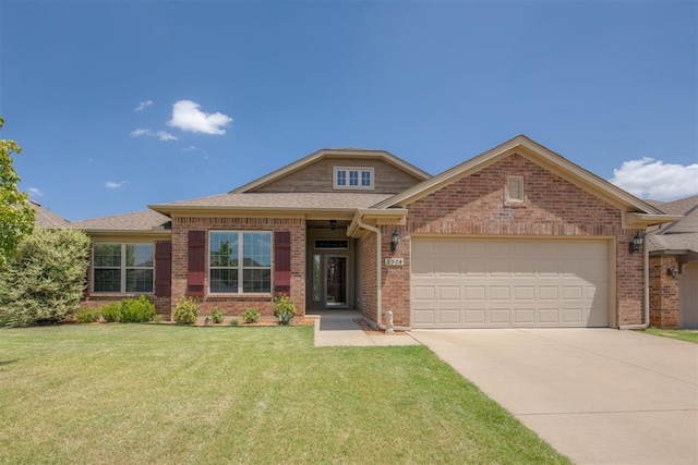 view of front of house with driveway, roof with shingles, an attached garage, a front lawn, and brick siding