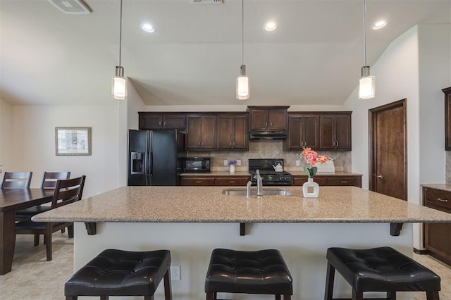 kitchen with decorative backsplash, black appliances, dark brown cabinetry, and a sink