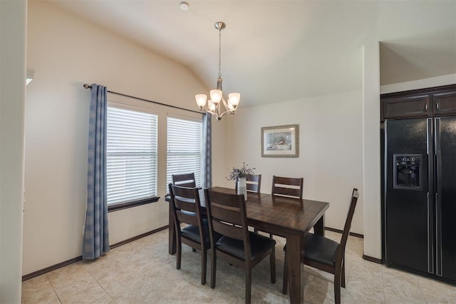 dining space with light tile patterned floors, a notable chandelier, baseboards, and lofted ceiling