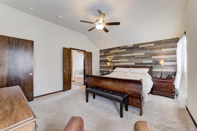 bedroom with connected bathroom, baseboards, vaulted ceiling, carpet flooring, and a ceiling fan