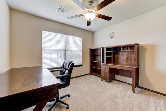 carpeted office space with visible vents, baseboards, and ceiling fan