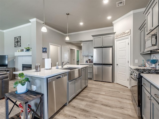 kitchen featuring visible vents, gray cabinets, stainless steel appliances, and open floor plan