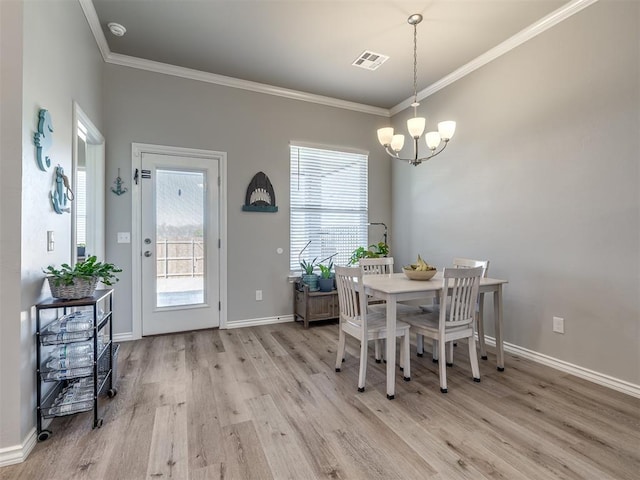 dining area featuring a healthy amount of sunlight, light wood-style flooring, and ornamental molding