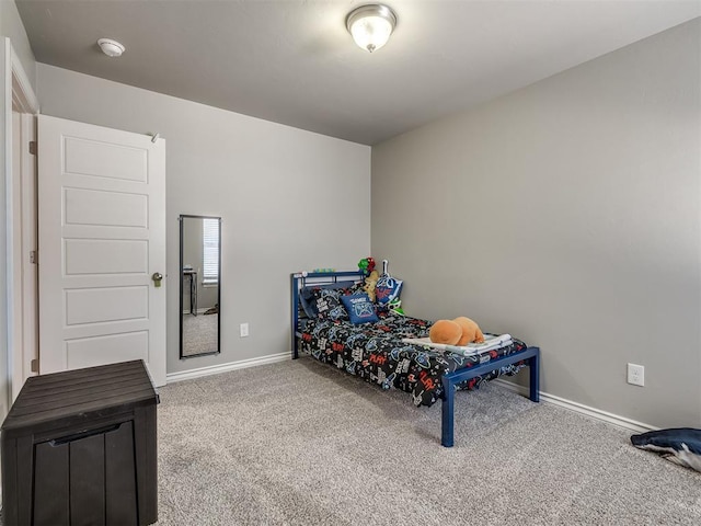 carpeted bedroom featuring baseboards