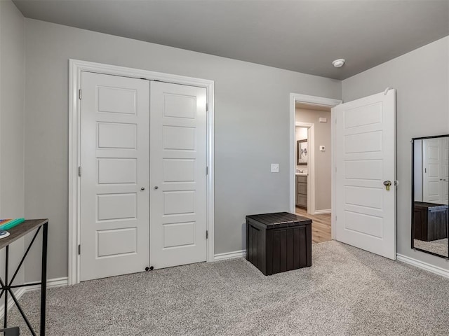 bedroom featuring baseboards, a closet, and carpet floors