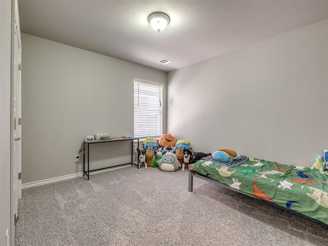 carpeted bedroom with visible vents and baseboards