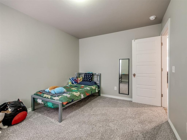 bedroom featuring baseboards and carpet flooring