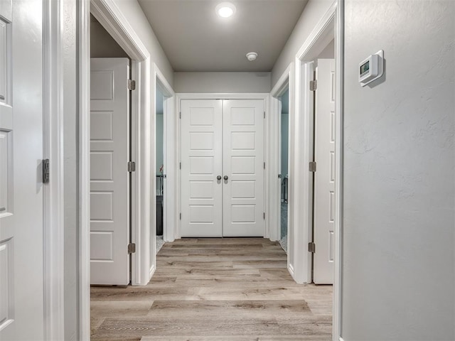 corridor featuring light wood finished floors