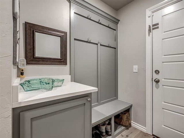 mudroom featuring baseboards and light wood-style floors