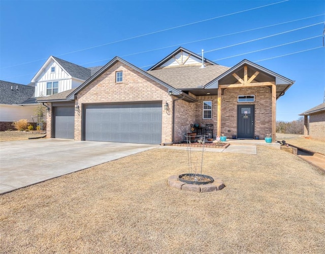 view of front of home featuring driveway, an attached garage, a shingled roof, board and batten siding, and brick siding