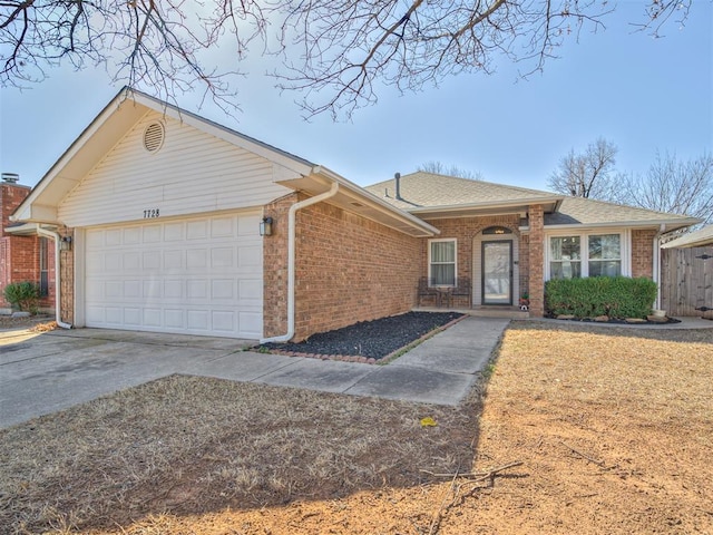 single story home featuring concrete driveway, a garage, brick siding, and roof with shingles