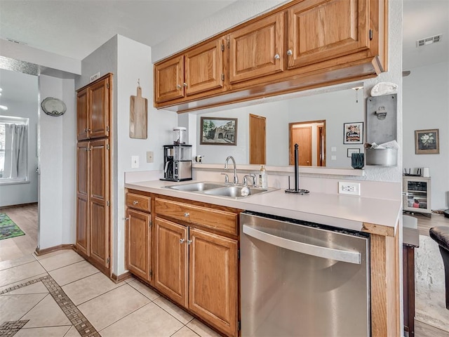 kitchen with visible vents, dishwasher, light countertops, and a sink