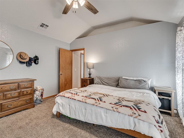 carpeted bedroom featuring vaulted ceiling, baseboards, visible vents, and ceiling fan