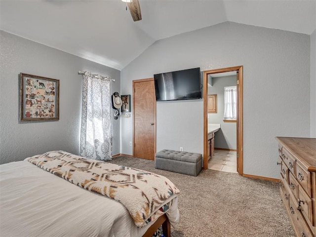 bedroom with light carpet, a ceiling fan, connected bathroom, baseboards, and vaulted ceiling