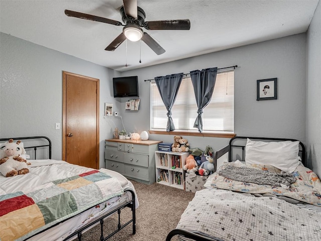 bedroom featuring carpet flooring, ceiling fan, and a textured wall