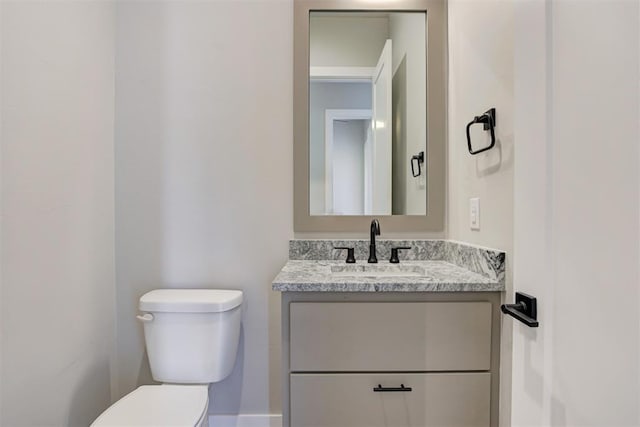 bathroom with toilet and vanity