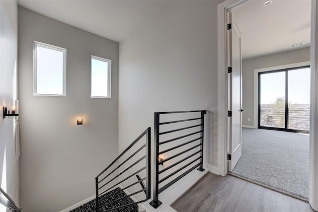 stairway featuring baseboards and wood finished floors