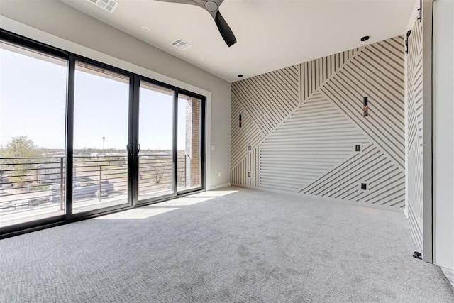 interior space with visible vents, a ceiling fan, and carpet floors