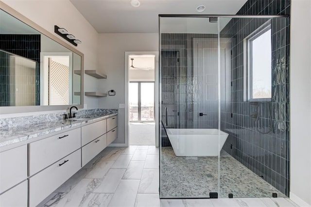 full bathroom with a soaking tub, a shower stall, vanity, and marble finish floor