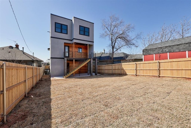 back of property featuring stucco siding and a fenced backyard