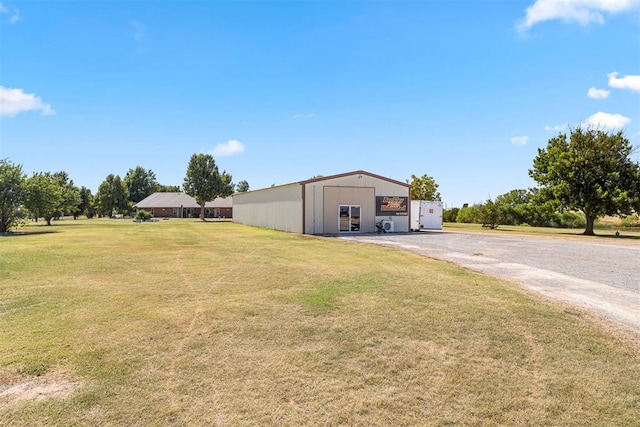 view of pole building featuring a yard and driveway