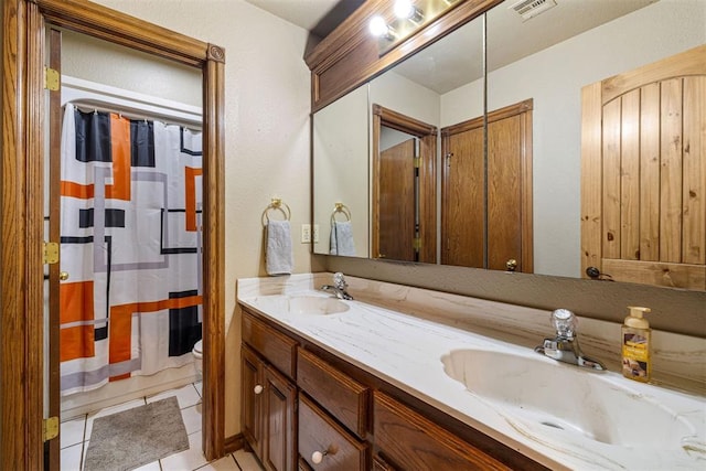 full bath with a sink, visible vents, toilet, and tile patterned floors