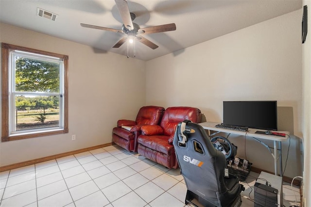 home office with a ceiling fan, light tile patterned floors, baseboards, and visible vents