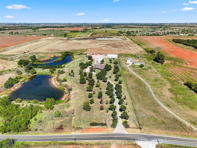 drone / aerial view featuring a water view and a rural view