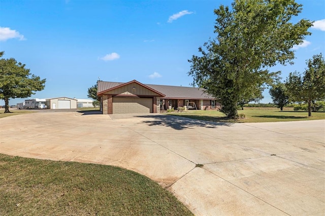 ranch-style house with brick siding, driveway, and a front lawn