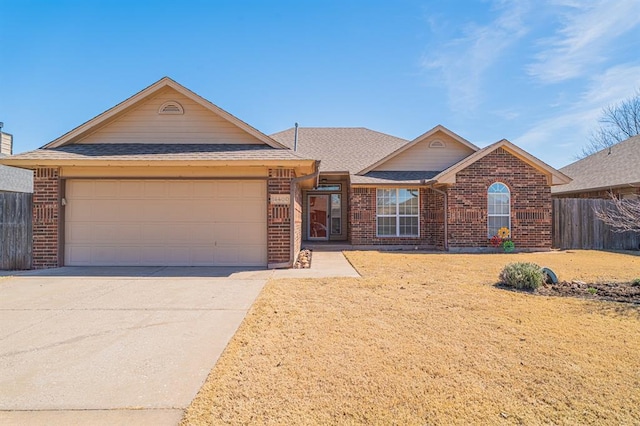 ranch-style house with brick siding, fence, concrete driveway, roof with shingles, and a garage