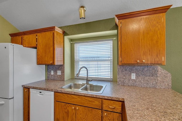 kitchen featuring white appliances, brown cabinetry, a sink, light countertops, and tasteful backsplash