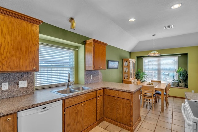 kitchen featuring white appliances, tasteful backsplash, visible vents, and a sink