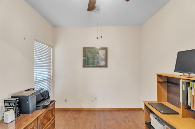 home office with visible vents, baseboards, ceiling fan, and wood finished floors