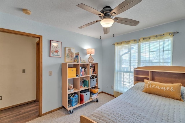 bedroom with baseboards, a textured ceiling, and ceiling fan