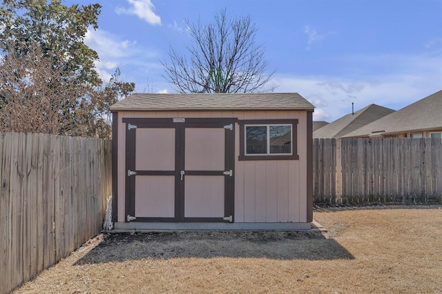 view of shed with a fenced backyard