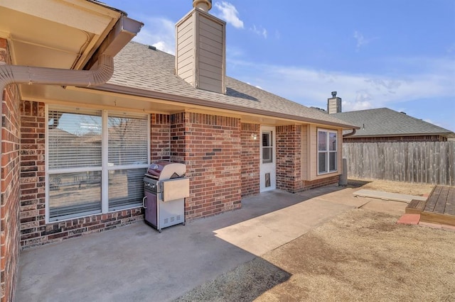 view of patio / terrace featuring grilling area and fence