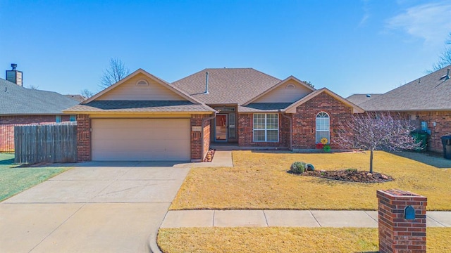 view of front of property with a front yard, an attached garage, brick siding, and roof with shingles