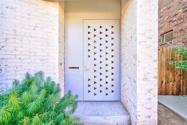 property entrance featuring brick siding