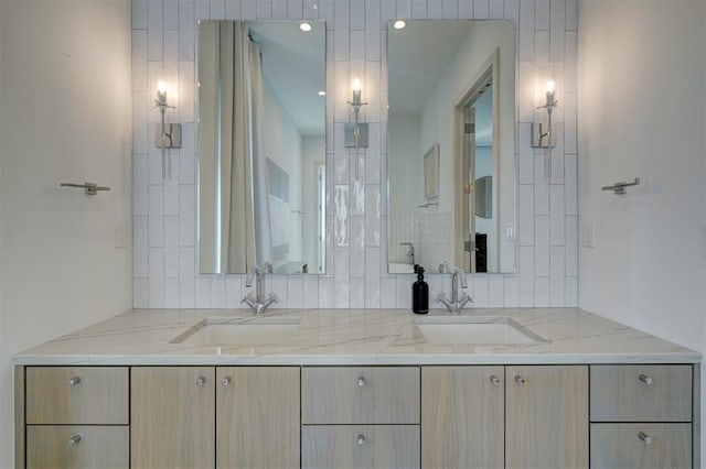 full bathroom featuring double vanity and a sink