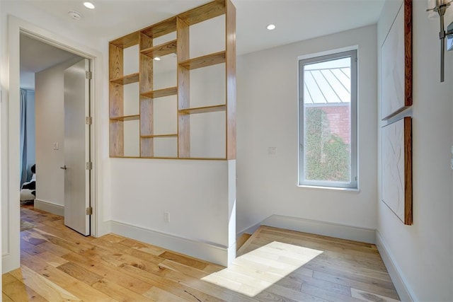 spare room with recessed lighting, baseboards, and light wood-style flooring