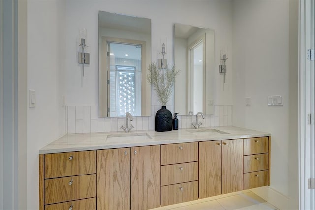 bathroom with a sink, tasteful backsplash, and double vanity