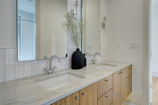 full bathroom with a sink and double vanity